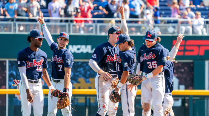Jun 23, 2022; Omaha, NE, USA; Ole Miss Rebels center fielder TJ McCants (16), shortstop Jacob Gonzalez (7), first baseman Tim Elko (25), second baseman Peyton Chatagnier (1) and left fielder Kevin Graham (35) celebrate after defeating the Arkansas Razorbacks to advance to the final series of the College World Series at Charles Schwab Field.